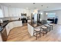 Modern kitchen featuring white cabinets, stainless steel appliances, and a large center island with seating at 4715 W Chapin Ave, Tampa, FL 33611