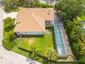 Aerial view of home showcasing a large screened-in pool, tile roof, and well-maintained backyard at 4766 Royal Palm Ne Cir, St Petersburg, FL 33703