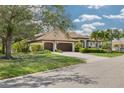 Attractive one-story house boasting an attached two-car garage, sprawling lawn, and tropical landscaping at 4766 Royal Palm Ne Cir, St Petersburg, FL 33703