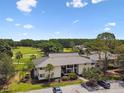 Stunning aerial view of condo building and well-manicured golf course creating a park-like community at 4946 Mill Pond Rd # 3180, Wesley Chapel, FL 33543