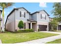 Beautiful home featuring a well-maintained lawn, two-car garage, and pleasing exterior color scheme at 5014 Fallen Leaf Dr, Riverview, FL 33578