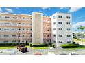 Exterior of building with multiple levels, balconies, parking lot and landscaping at 5623 80Th N St # 202, St Petersburg, FL 33709