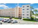 Exterior of building with multiple levels, balconies, parking lot and landscaping at 5623 80Th N St # 202, St Petersburg, FL 33709