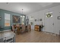 Stylish dining room with wood floors, modern chandelier, and a decorative deer art piece at 710 W River Heights Ave, Tampa, FL 33603