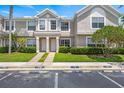 Inviting townhome exterior with lush landscaping and designated visitor parking spaces at 732 Kensington Lake Cir, Brandon, FL 33511