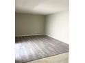 Spacious living room showcasing updated flooring and neutral wall colors at 7506 Presley Pl # 107, Tampa, FL 33617