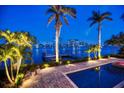 Backyard pool and private dock with stunning waterfront views and city skyline in the background at 755 Bay Esplanade, Clearwater Beach, FL 33767