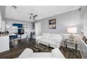 Bright living room featuring a ceiling fan, minimalist decor, and seamless flow into the adjacent kitchen and entertainment area at 8444 8Th N Way, St Petersburg, FL 33702
