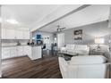 Open concept living room features modern white furniture, sleek flooring, and a seamless transition to the kitchen area at 8444 8Th N Way, St Petersburg, FL 33702