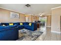 Spacious living room featuring tile floors, modern lighting, and comfortable seating arrangement at 8531 Woodcrest Dr, Port Richey, FL 34668