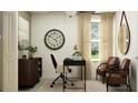 Bright office with neutral tones, a large clock, and comfortable seating at 9511 Runaway Breeze Dr, Land O Lakes, FL 34637