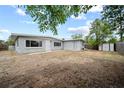 Spacious backyard with a partial fence and shed at 10602 Camelia Dr, Port Richey, FL 34668