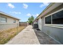 Side yard with gray exterior at 10602 Camelia Dr, Port Richey, FL 34668