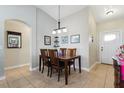 Inviting dining room showcasing a classic wooden table, decorative accents, and neutral tile flooring at 13308 Prestwick Dr, Riverview, FL 33579