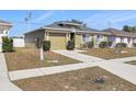 View of the house with a two car garage, showing the driveway and walkway leading to the front door at 13308 Prestwick Dr, Riverview, FL 33579