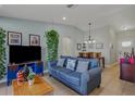 Cozy living room featuring a blue sofa, modern decor, and ample natural light at 13308 Prestwick Dr, Riverview, FL 33579