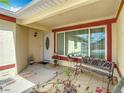 Inviting front porch with tiled flooring, a bench, decorative plants, and a white front door at 1432 Windjammer Pl, Valrico, FL 33594