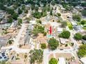 An aerial view shows a home with a private backyard pool nestled within a lush, tree-filled neighborhood at 202 Cranberry Ln, Brandon, FL 33510
