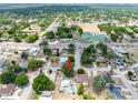 An aerial view of a home featuring a private pool and well-manicured lawns in a quiet neighborhood at 202 Cranberry Ln, Brandon, FL 33510