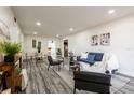 Bright and airy living room with modern furnishings, neutral decor, and wood-look flooring at 202 Cranberry Ln, Brandon, FL 33510