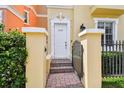 Inviting front entrance featuring a white door, decorative columns, and well-maintained landscaping at 2305 Victoria Gardens Ln, Tampa, FL 33609