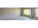 Bright, open living area with lots of natural light, a neutral palette and wood look floors at 2360 World Parkway Blvd # 36, Clearwater, FL 33763