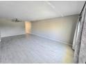 Spacious living room with a ceiling fan, neutral walls and flooring, with natural light at 2360 World Parkway Blvd # 36, Clearwater, FL 33763