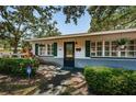 Inviting front entrance with green shutters, trimmed hedges, and an ADT security sign for added peace of mind at 2880 81St N St, St Petersburg, FL 33710