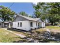 Charming single-story home with a tidy lawn and flowerbeds in front of the windows at 308 E 121St Ave, Tampa, FL 33612