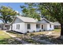 Charming single-story home with a tidy lawn and flowerbeds in front of the windows at 308 E 121St Ave, Tampa, FL 33612