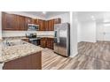 Modern kitchen boasts stainless steel appliances, granite countertops, and stylish cabinets at 32713 Brooks Hawk Ln, Wesley Chapel, FL 33543