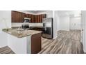 Contemporary kitchen featuring stainless steel appliances, granite countertops, and wood cabinets at 32713 Brooks Hawk Ln, Wesley Chapel, FL 33543