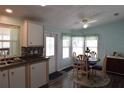 Inviting dining area next to kitchen, featuring light blue walls and laminate floors at 37643 Campo Ave, Zephyrhills, FL 33541