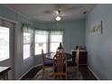 Bright dining area with blue walls, wooden table, and natural light from the windows at 37643 Campo Ave, Zephyrhills, FL 33541