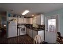 Functional kitchen featuring a stove, microwave, and tile backsplash at 37643 Campo Ave, Zephyrhills, FL 33541