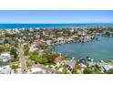 Stunning aerial view of the property nestled among lush greenery and waterfronts in a picturesque neighborhood at 425 12Th Ave, Indian Rocks Beach, FL 33785