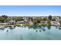Picturesque waterfront property featuring a private dock with boat lifts and beautiful views of the waterway at 425 12Th Ave, Indian Rocks Beach, FL 33785