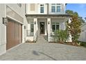 Gorgeous home showcasing a covered porch and brick driveway at 429 Erie Ave, Tampa, FL 33606