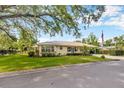 Charming single-story home featuring a metal roof, well-manicured lawn and mature landscaping, including a large shade tree at 509 N Walker St, Plant City, FL 33563