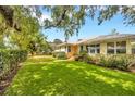 Well-maintained house with lush green lawn and mature landscaping; the exterior of the home is a welcoming yellow color at 509 N Walker St, Plant City, FL 33563
