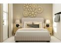 Inviting bedroom featuring a plush upholstered bed, coordinating nightstands with lamps, and a calming neutral color palette at 5662 Red Kite Dr, Wimauma, FL 33598