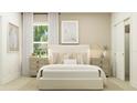 Bright bedroom featuring neutral tones, framed artwork, bedside tables with lamps, plush bedding, and a closet at 6909 E 116Th Ct, Palmetto, FL 34221
