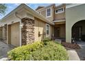 Charming townhome exterior featuring stone details, lush landscaping, and a welcoming entrance at 8132 Stone Path Way, Tampa, FL 33647