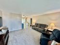 Cozy living room with neutral walls, plush carpet, comfortable furniture, and an inviting atmosphere at 9743 36Th N Way # 4, Pinellas Park, FL 33782