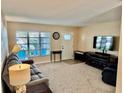 Inviting living room with a bright window, neutral tones, and cozy furnishings create a relaxing space at 9743 36Th N Way # 4, Pinellas Park, FL 33782
