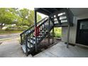 Staircase leading to the condo entrance complemented by a lush green landscape at 11201 122Nd Ave # 103, Largo, FL 33778