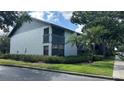 This angle of the condo shows well-maintained landscaping, healthy lawn, and a screened balcony at 11201 122Nd Ave # 103, Largo, FL 33778