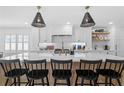 Bright kitchen featuring a large island, quartz countertops, and modern appliances at 1207 S Druid Ln, Tampa, FL 33629