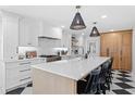 Bright kitchen featuring a large island, quartz countertops, and modern appliances at 1207 S Druid Ln, Tampa, FL 33629