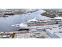 An impressive cruise ship is docked near industrial structures and lush green vegetation along the water at 1209 E Cumberland Ave # 2006, Tampa, FL 33602